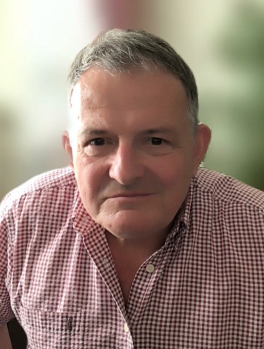 portrait photo of jo, he is wearing a pink shirt